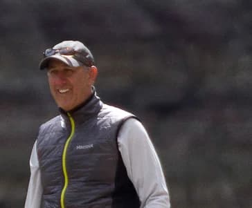 Lucky, Managing Partner at ClarifyADA, outdoors in a cap and quilted vest.